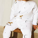 Grenouillère à fermeture éclair en bambou et coton biologique avec motif cheval à bascule